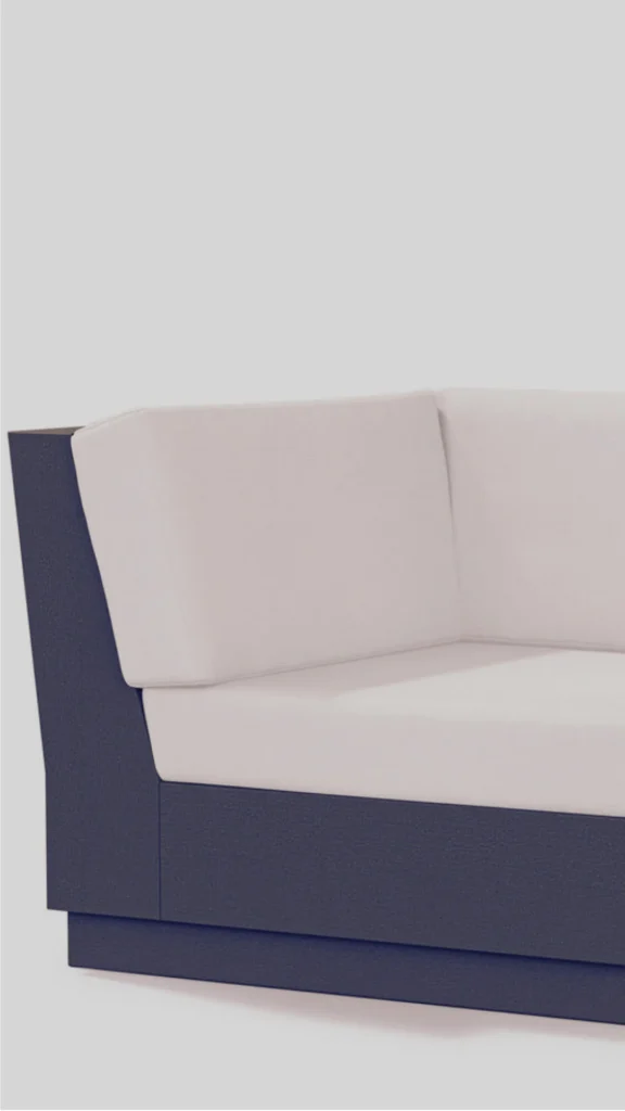 A minimalist close-up of a modern structural lounge sofa designed to anchor a dedicated reading nook or conversation zone. The furniture piece features a stark, high-contrast palette with a dark anthracite or deep midnight blue-grey outer architectural shell. Thick, plush cream-colored back and seat cushions rest perfectly inside the frame, emphasizing clean lines and tailored contemporary luxury.
