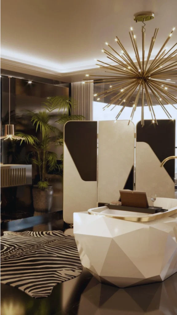 An ultra-luxurious, contemporary master bathroom that showcases sophisticated contrast and geometric compositions over simple ornamentation. A dramatic, white freestanding bathtub with a faceted origami-like geometric shell features a polished brass rim. The glossy black stone flooring is paired with a bold zebra-print area rug and a multi-panel black and cream folding screen, all illuminated by a massive, sculptural brass starburst chandelier.