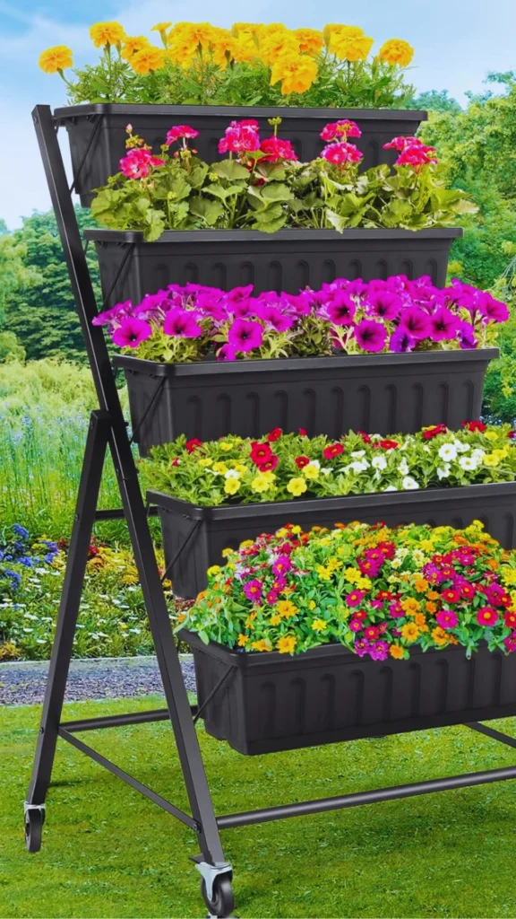 A mobile, tiered vertical garden display showcasing how intentional planter structure can organize and elevate premium outdoor or indoor landscaping. The black metal A-frame stand on wheels holds five levels of long, dark rectangular planter boxes. Each tier features a distinct variety of vibrant blooms—ranging from top to bottom with bright yellow marigolds, pink geraniums, deep purple petunias, white and red annuals, and a dense mix of colorful wildflowers—creating a highly structured, textured floral arrangement.