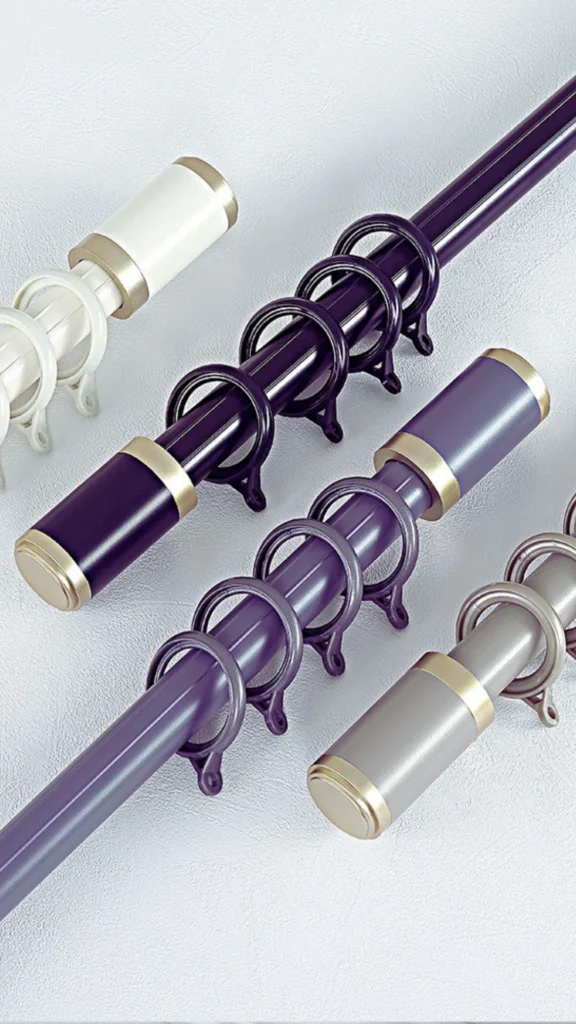 A high-angle view of four different contemporary curtain rods arranged diagonally on a white textured surface. Each metal pole features a set of matching large curtain rings and a smooth, clean-lined cylindrical finial tip decorated with a gold metallic ring accent. The colors of the hardware include dark violet, soft purple, metallic slate grey, and ivory white, emphasizing clean-lined, modern structural choices for window treatments.