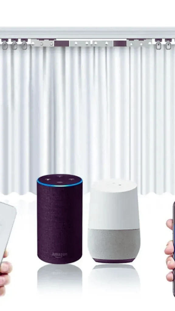 A product illustration showing automated smart home accessories for window treatments against a white background. It features a set of white pleated drapes attached to an electronic curtain rail track. Positioned in front are two popular voice assistants—a dark purple Amazon Echo cylinder and a white and grey Google Home device. A hand holding a physical remote control is visible on the far left, while another hand holding a mobile phone is on the far right.